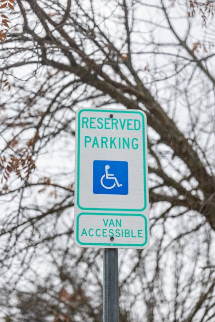 A vertical metal signpost displaying multiple parking and stopping regulations, including a red and white 'Tow-Away No Stopping' notice from 3 PM to 7 PM, with additional restrictions for no parking from 7 AM to 9 AM on Tuesdays for street cleaning. Below these, a green and white sign indicates a two-hour parking limit from 8 AM to 3 PM, Monday to Saturday, for vehicles with a C area permit. The signpost is set against a backdrop of dense green trees with sunlight filtering through the leaves, situated along a paved pavement. This signage is relevant for residents and visitors planning to execute home relocations or moving activities within Grove Park, highlighting restrictions to avoid parking fines during furniture transport or loading and unloading processes, as managed by Man with Van Grove Park.